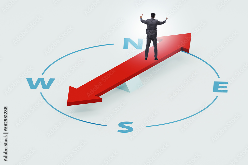 Businessman with compass looking for direction Businessman with compass looking for direction