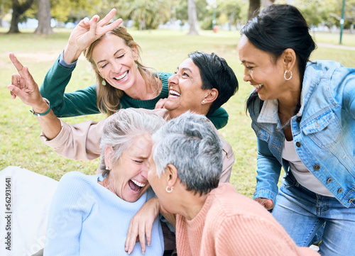 Retirement, women and laughing in funny games, comic bonding and silly global activity with peace sign hands. Smile, happy and elderly senior friends in nature park, grass garden or community support