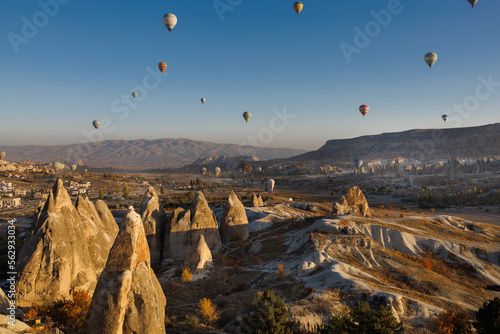 Cappadocia. View of Goreme town with caves and hot air balloons in Cappadocia. Turkey.