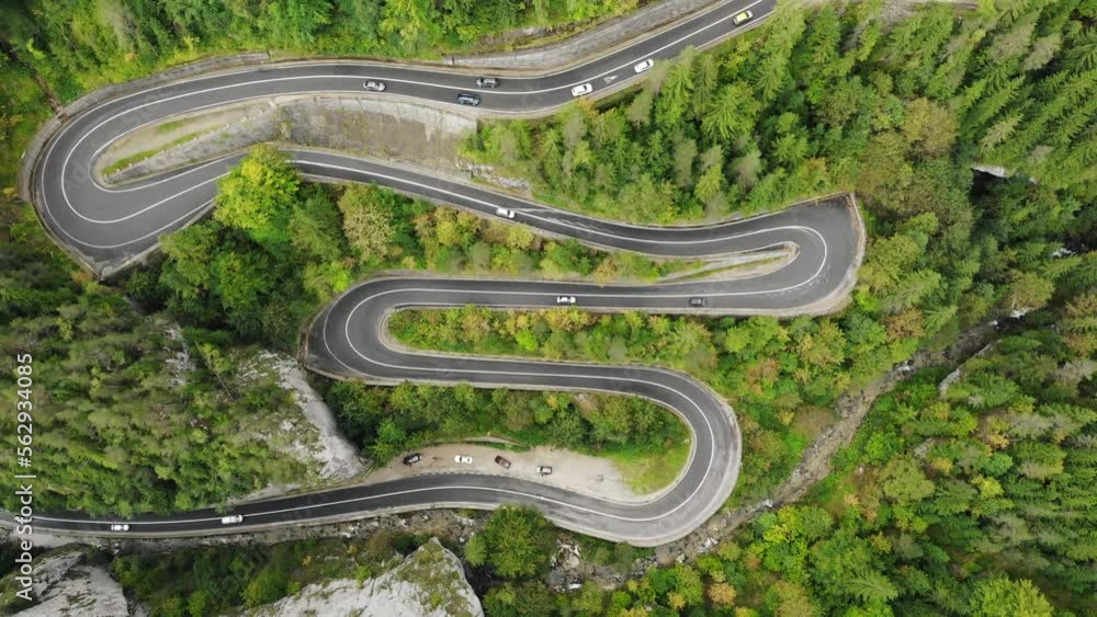 Overhead View Of Vehicles Driving On Serpentine Highway In Cheile Bicazului, North-eastern Romania. Aerial Shot Overhead View Of Vehicles Driving On Serpentine Highway In Cheile Bicazului, North-eastern Romania. Aerial Shot
