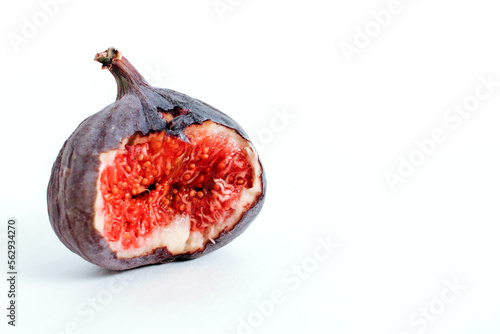 Bitten Fresh raw juicy fig isolated on white background