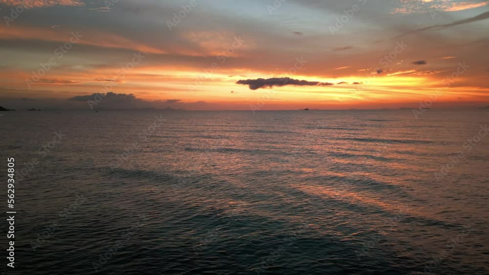 Cinematic shot of time after sunset over the sea. A beautiful golden-orange sunset sky reflected in the sea water. The beauty of mother earth. Aerial view, the drone camera moves away. Cinematic shot of time after sunset over the sea. A beautiful golden-orange sunset sky reflected in the sea water. The beauty of mother earth. Aerial view, the drone camera moves away.
