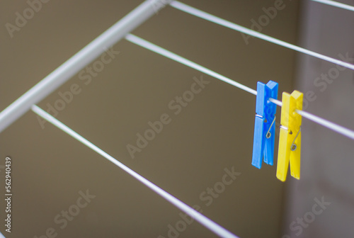 Clothing peg on washing line. Clothing pins on clothesline. Clothes pin in ukrainian colors. Blue and yellow pegs. Laundry concept. Household equipment. Ukrainian national colors. 
