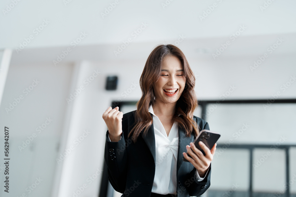 Business work concept, portrait of a young businesswoman holding a cell phone showing a happy expression, business success. Business work concept, portrait of a young businesswoman holding a cell phone showing a happy expression, business success.