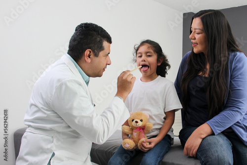 Photography Latina mother cares for and accompanies her curly little daughter at the dark-ha