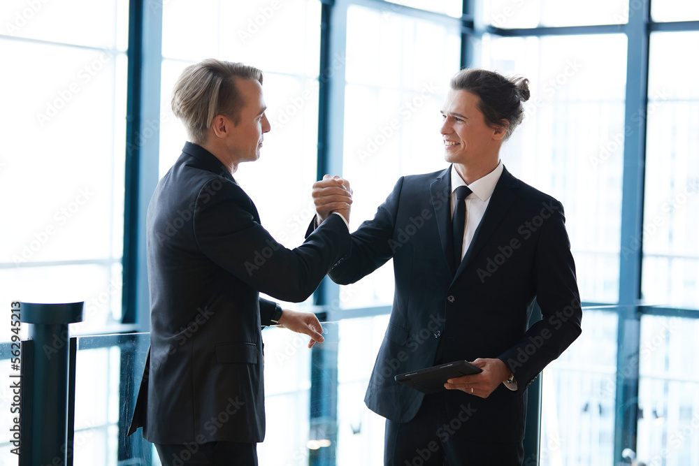 businessman shaking hands with friends and having fun in the office businessman shaking hands with friends and having fun in the office