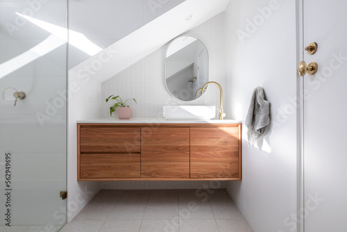 Fototapeta Modern white bathroom stone benchtop timber vanity gold brass tap sink mirror ti