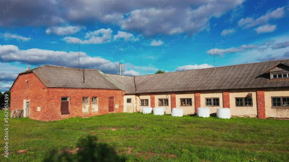 Old red brick building, grunge warehouse on sunny summer day with blue sky above Old red brick building, grunge warehouse on sunny summer day with blue sky above