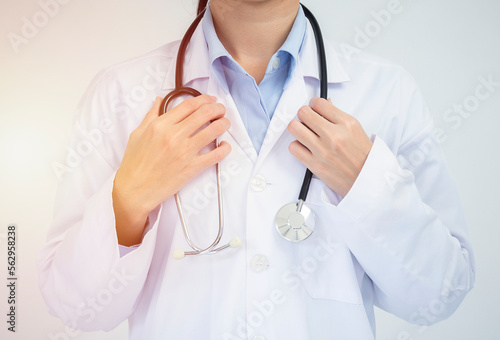 Crop image of professional confident young female asian doctor in white coat, stethoscope over neck