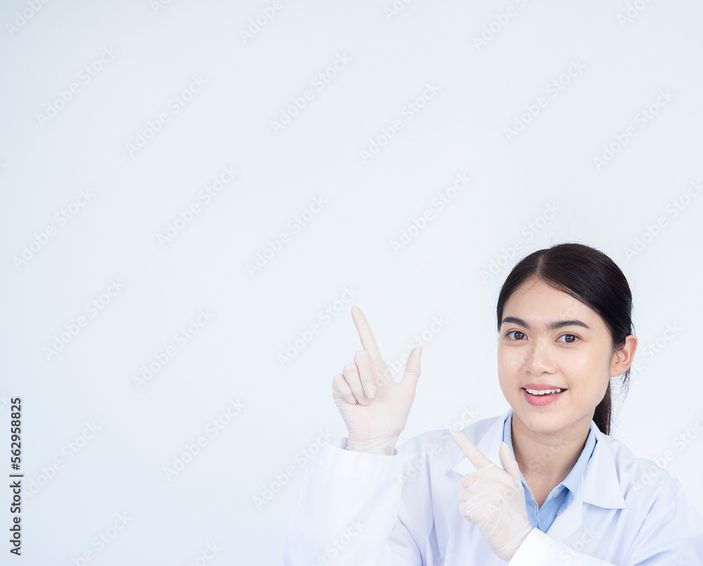 Young Asian woman working at scientist laboratory smiling and looking at the camera pointing with two hands and fingers to the side. Young Asian woman working at scientist laboratory smiling and looking at the camera pointing with two hands and fingers to the side.