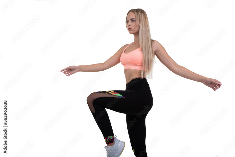 A sporty young woman in a pink top, leggings and sneakers does exercises on a white background A sporty young woman in a pink top, leggings and sneakers does exercises on a white background