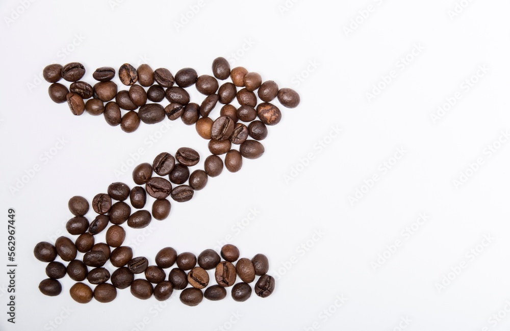 Z is a capital letter of the English alphabet made up of natural roasted coffee beans that lie on a white background. Plenty of space to put text or pictures, top view and studio photography. Z is a capital letter of the English alphabet made up of natural roasted coffee beans that lie on a white background. Plenty of space to put text or pictures, top view and studio photography.