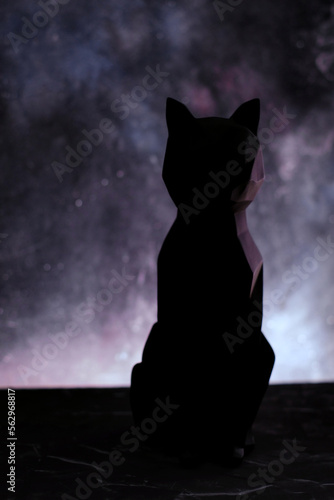 Black cat silhouette over blur starry background. Vertical orientation