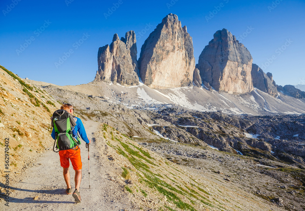 Young dad with baby boy travelling with backpack. Father on hiking adventure with child, family trip in mountains. Vacations journey with infant National Park Tre Cime di Lavaredo, Dolomites, Italy