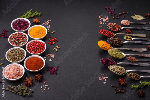 Fototapeta Naklejka Na Ścianę i Meble -  Composition consisting of variations of spices in white bowls and metal spoons