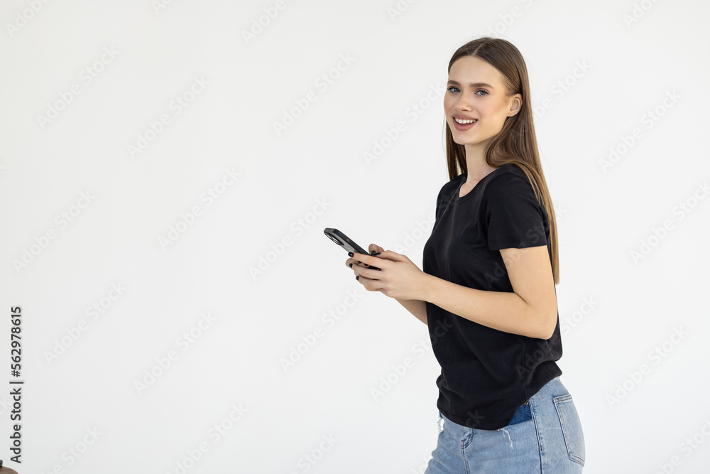 Portrait of a smiling woman holding smartphone over white background Portrait of a smiling woman holding smartphone over white background