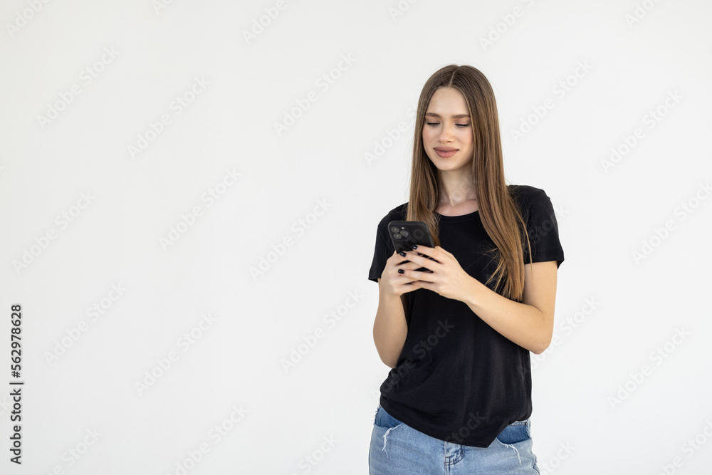 Portrait of a smiling woman holding smartphone over white background Portrait of a smiling woman holding smartphone over white background