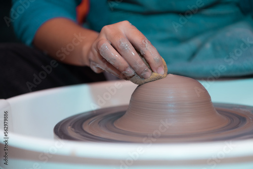 Pottery artist, Young female making a piece of clay molding calmly and meticulously In order to produce the most attractive work possible,