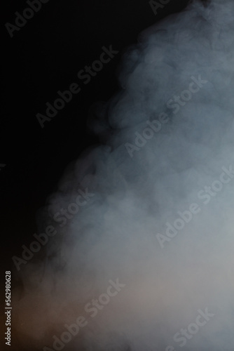 Dense Fluffy Puffs of White Smoke and Fog on black Background, Abstract Smoke Clouds, Movement Blurred out of focus. Smoking blows from machine dry ice fly fluttering in Air, effect texture