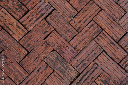 Walkway is paved with brown bricks