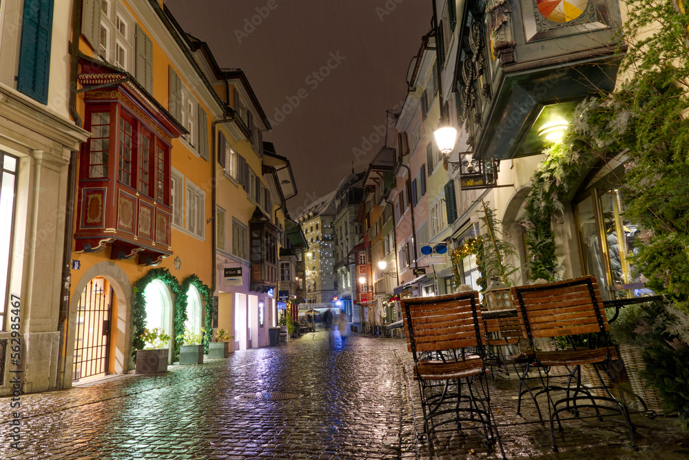 Famous alley named Augustinergasse on a snowy late autumn night with beautiful decorated stores and shops at City of Zürich. Photo taken December 10th, 2022, Zurich, Switzerland.