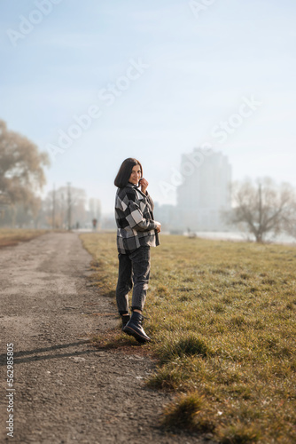 Autumn portrait of an attractive young woman in the morning, outdoors