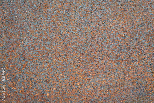 Closeup photo of rusty old metal surface. Orange and gray colors mottled background. 