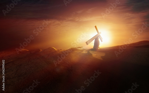 Leinwand Poster Light and clouds on a sunset hill and Jesus carrying the cross of suffering symb