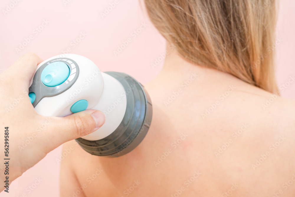 Men's hands massage females neck and shoulder by massager Men's hands massage females neck and shoulder by massager