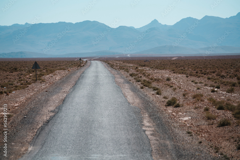 Country road against mountain ranges Country road against mountain ranges