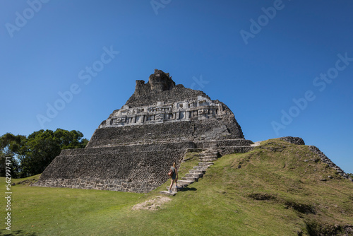 Woman walking towards Mayan ruin photo