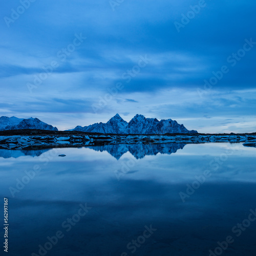 Reflection of VÃ¥gakallen mountain peak over coastline, VestvÃ¥gÃ¸y, Lofoten Islands, Norway photo