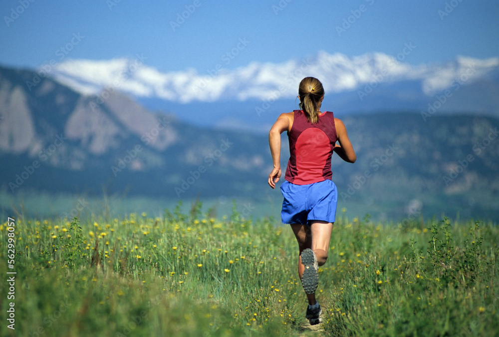 A woman trail running near Boulder, CO. A woman trail running near Boulder, CO.