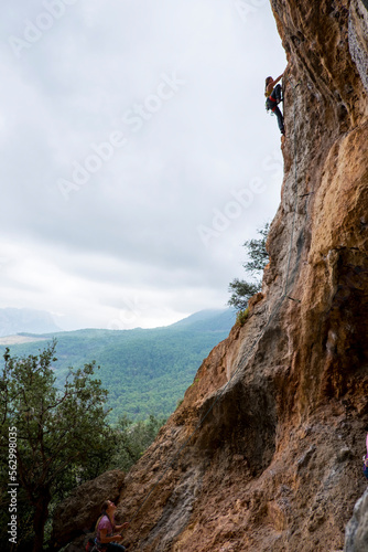 A woman rock climbing in Geyikbayiri, Turkey photo