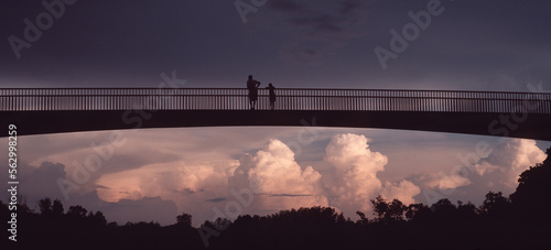 People watch thunderstorm clouds build, Northern Territory, Australia.