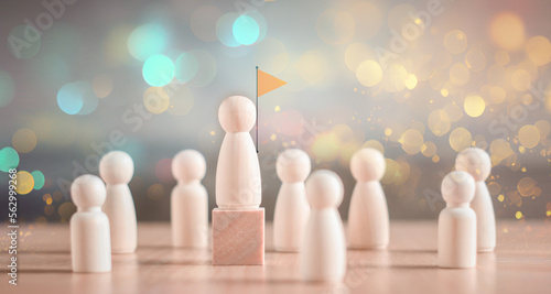 Fotografie Wooden figure standing on a cube higher than others - concept of leadership or h