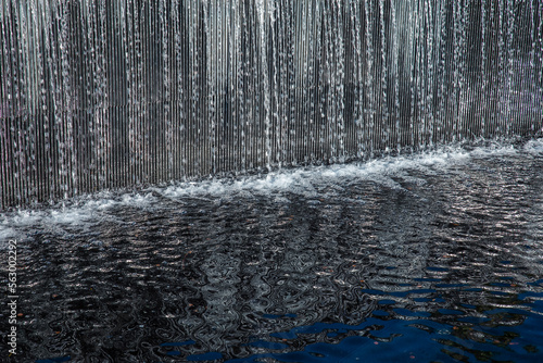 decorative artificial water curtain on the pond © kemirada