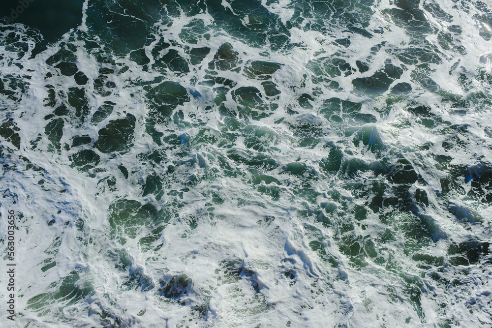 Background. The texture of the ocean. Top view of sea waves, water, sea foam Background. The texture of the ocean. Top view of sea waves, water, sea foam