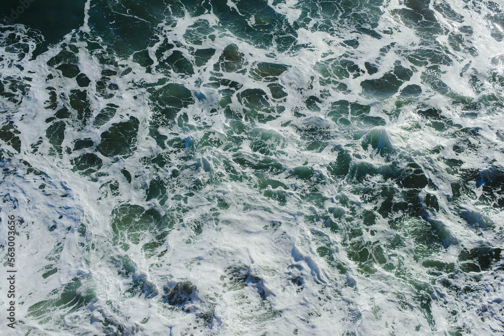 Background. The texture of the ocean. Top view of sea waves, water, sea foam