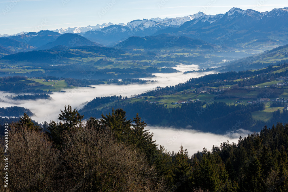 Landscape of Austrian mountains, blue sky and fog