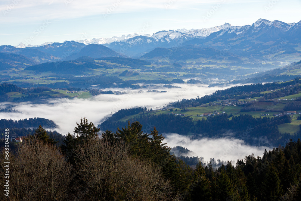 Austrian mountains landscape with fog, blue sky