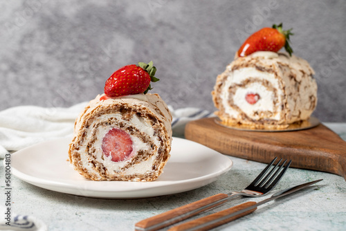 Strawberry Roll Cake. Log cake with cream and strawberries on a stone background. close up