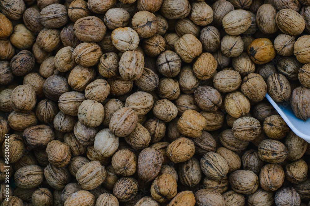 Background. The texture of walnuts scattered in a box Background. The texture of walnuts scattered in a box