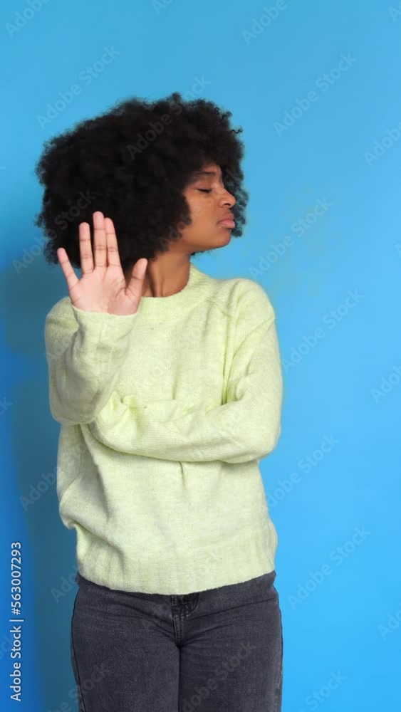 Thoughtful black woman doing a negation gesture. Vertical video. Thoughtful black woman doing a negation gesture. Vertical video.