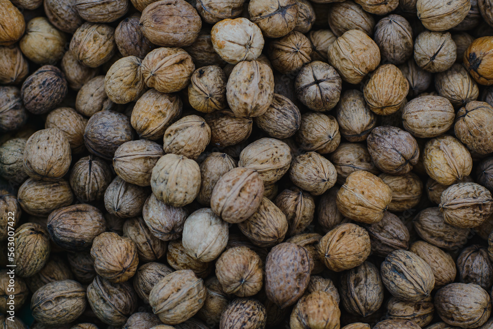 Background. The texture of walnuts scattered in a box Background. The texture of walnuts scattered in a box