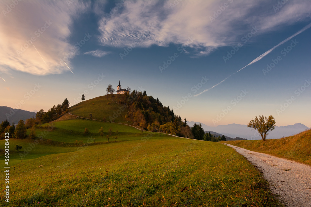 Fototapeta premium Picturesque landscape with church in Slovenia on green hill