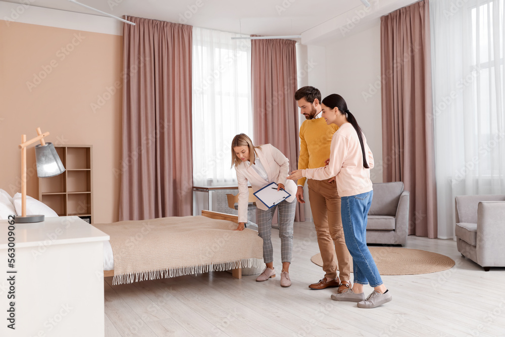 Real estate agent showing new apartment to couple Real estate agent showing new apartment to couple