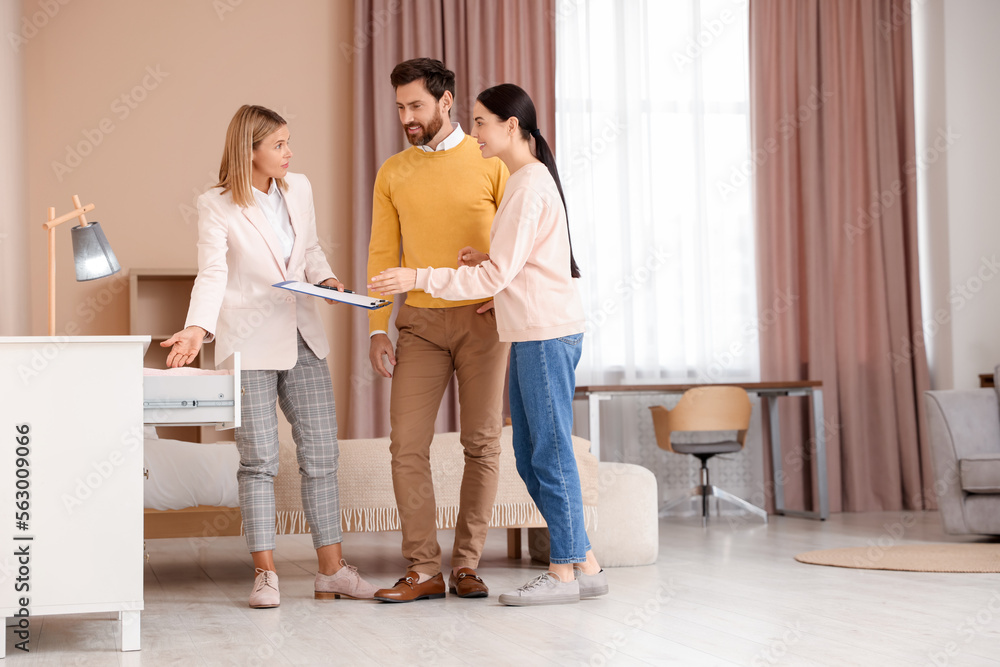 Real estate agent showing new apartment to couple Real estate agent showing new apartment to couple