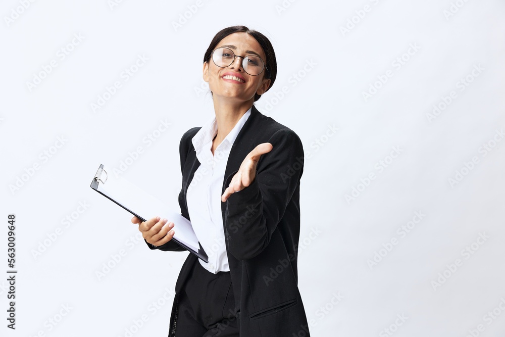 Business woman with a folder of documents in her hands in a black business suit and glasses shows signals gestures and emotions on a white background, work freelancer online training Business woman with a folder of documents in her hands in a black business suit and glasses shows signals gestures and emotions on a white background, work freelancer online training