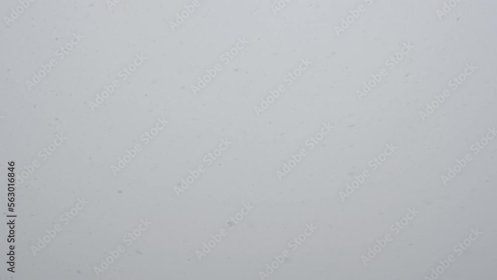 Slow motion snow falling over white clouds Slow motion snow falling over white clouds